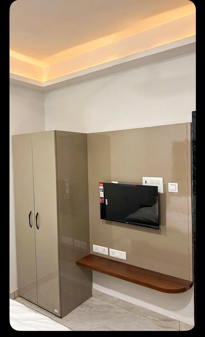 Wardrobe, wall-mounted television and writing shelf
